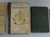 three old books sitting on a table next to each other
