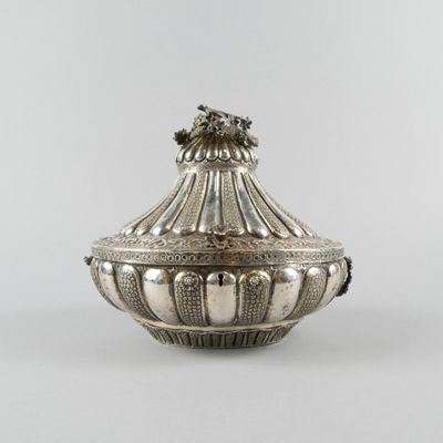 an antique silverplated sugar dish with a lion head on the lid