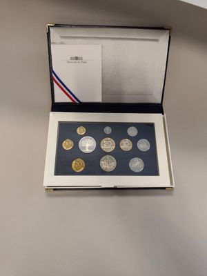 a box of coins with a picture of a man on it