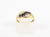 a close up of a gold ring with blue sapphires and diamonds