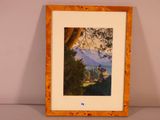 framed painting of a landscape with a castle in the distance