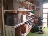a room with a shelf with baskets and boxes on it