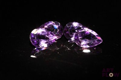 pair of purple amethtites on a black surface