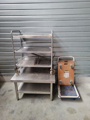a metal shelf with a metal tray on top of it
