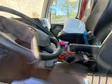 steering wheel of a truck with a bunch of items in it
