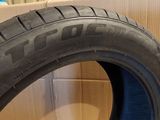 a close up of a tire on the ground next to a cardboard box