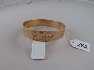 a bracelet that has a tag on it on a table