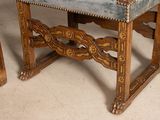 a blue upholstered chair sitting on a wooden table