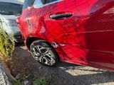 a red car that is parked next to other cars
