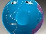 a blue bowl with a drawing of a man ' s face on it