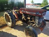 a red tractor that is parked on the side of the road