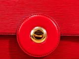close up of a red leather purse with a gold clasp