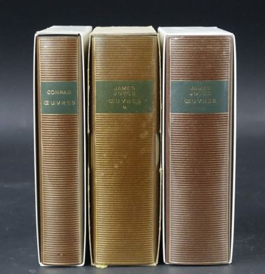 three books sitting on top of each other on a table