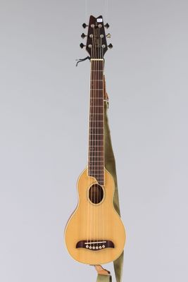an image of a guitar hanging from a string on a wall