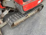 a red tractor that is parked on the side of the road