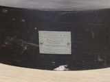 a black drum case sitting on top of a wooden table