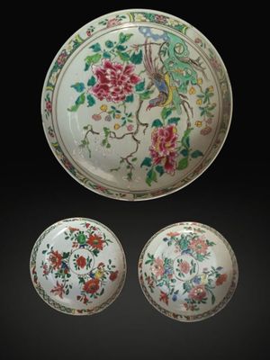 three pieces of chinese porcelain with flowers and birds on a black background