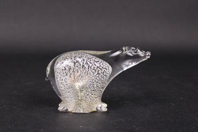 a glass figurine of a polar bear on a black surface
