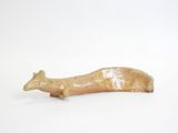 a small figurine of a dog on a white surface