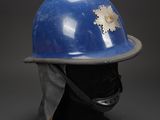 a close up of a helmet on a mannequin head on a black background