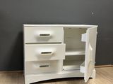 an image of a white dresser with drawers and a door open