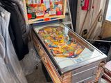 a pinball machine that is sitting in the middle of a room