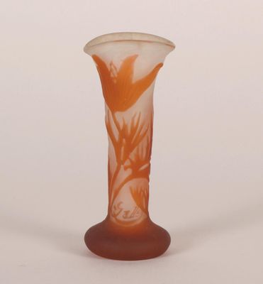 a glass vase that has a flower design on it