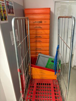 a metal cart with many boxes on it in a room