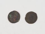 two ancient coins, one of which is a roman coin and the other of which is a roman coin