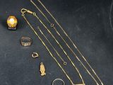 a close up of a bunch of gold jewelry on a table