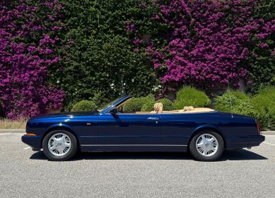 a picture of a blue convertible car parked in a parking lot