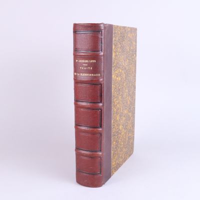 an old book sitting on top of a table next to a white wall