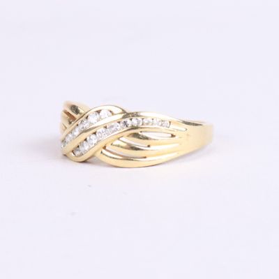 a close up of a gold ring with diamonds on a white background