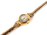 an image of a gold wrist watch with a chain around it
