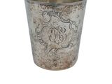 an old silver cup with a decorative design on it