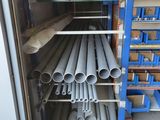 a lot of pipes that are stacked up in a rack