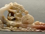 a figurine of a man on a boat on a body of water