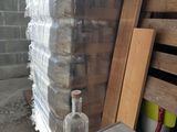a bottle of water sitting on a table next to a stack of pallets