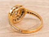 an image of a close up of a gold ring with diamonds