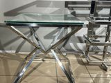 a glass table with a metal base and a glass top