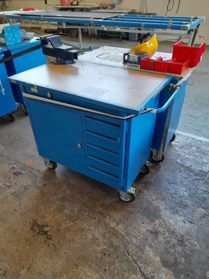 a blue work bench with a work table on it