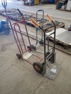a hand truck that is sitting in the middle of a warehouse