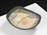 a small bowl sitting on top of a white table