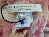 the label of a pink and white dress with pink flowers on it