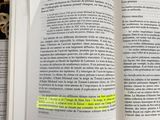 a book open on a bed with a yellow marker on it