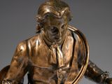 bronze statue of a man with a lasset and a dog