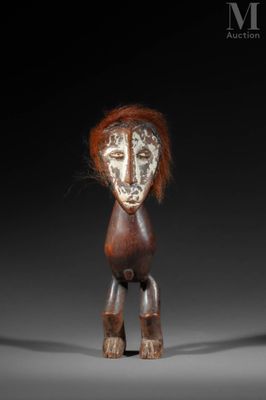 a close up of a wooden sculpture of a person with red hair