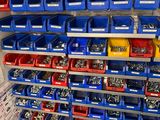 many bins of different types of screws on the wall