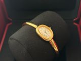 an image of a gold wrist watch in a black box