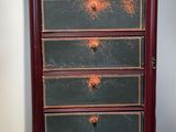 an old wooden chest of drawers with many drawers on top of it